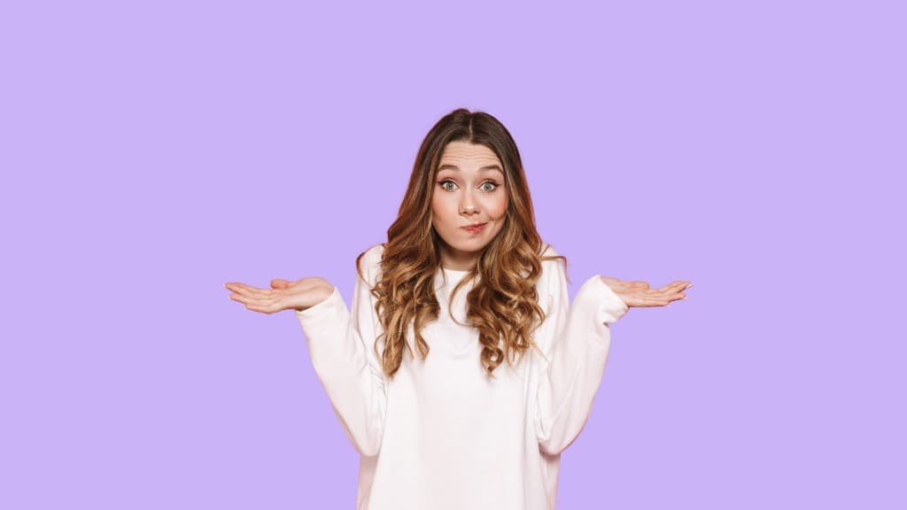 A woman looking uncertain while deciding what to wear